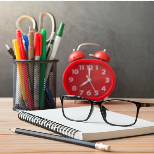 Pens and papers on a desk in preparation for a dyselxia assessment